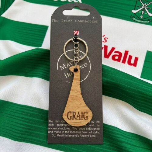 Handcrafted wooden hurley keychain engraved with GRAIG for Graiguenamanagh GAA & Camogie club on a black backing card